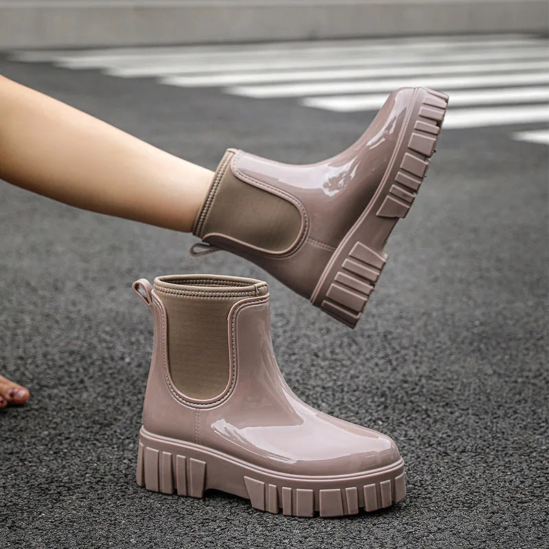Creamy-white low tube PVC rain boots with a flat heel and non-slip sole on a plain background.