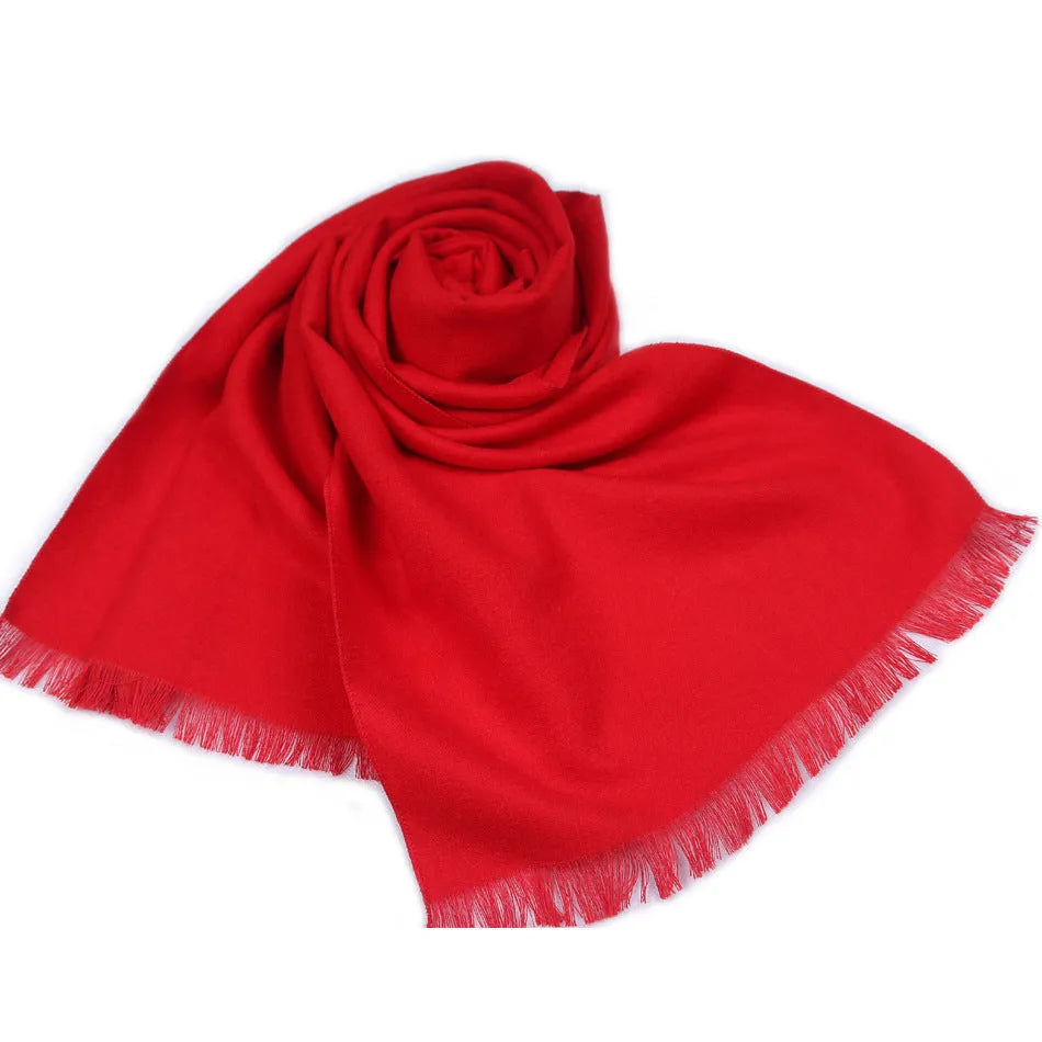 Men's solid red double-sided velvet scarf with tassel ends on a neutral background