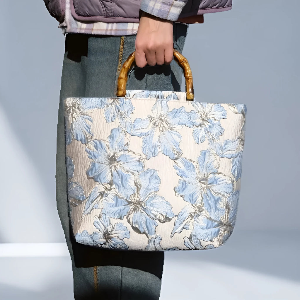 Light blue canvas shoulder bag with gold floral pattern showing 30x30x10 cm dimensions and double straps
