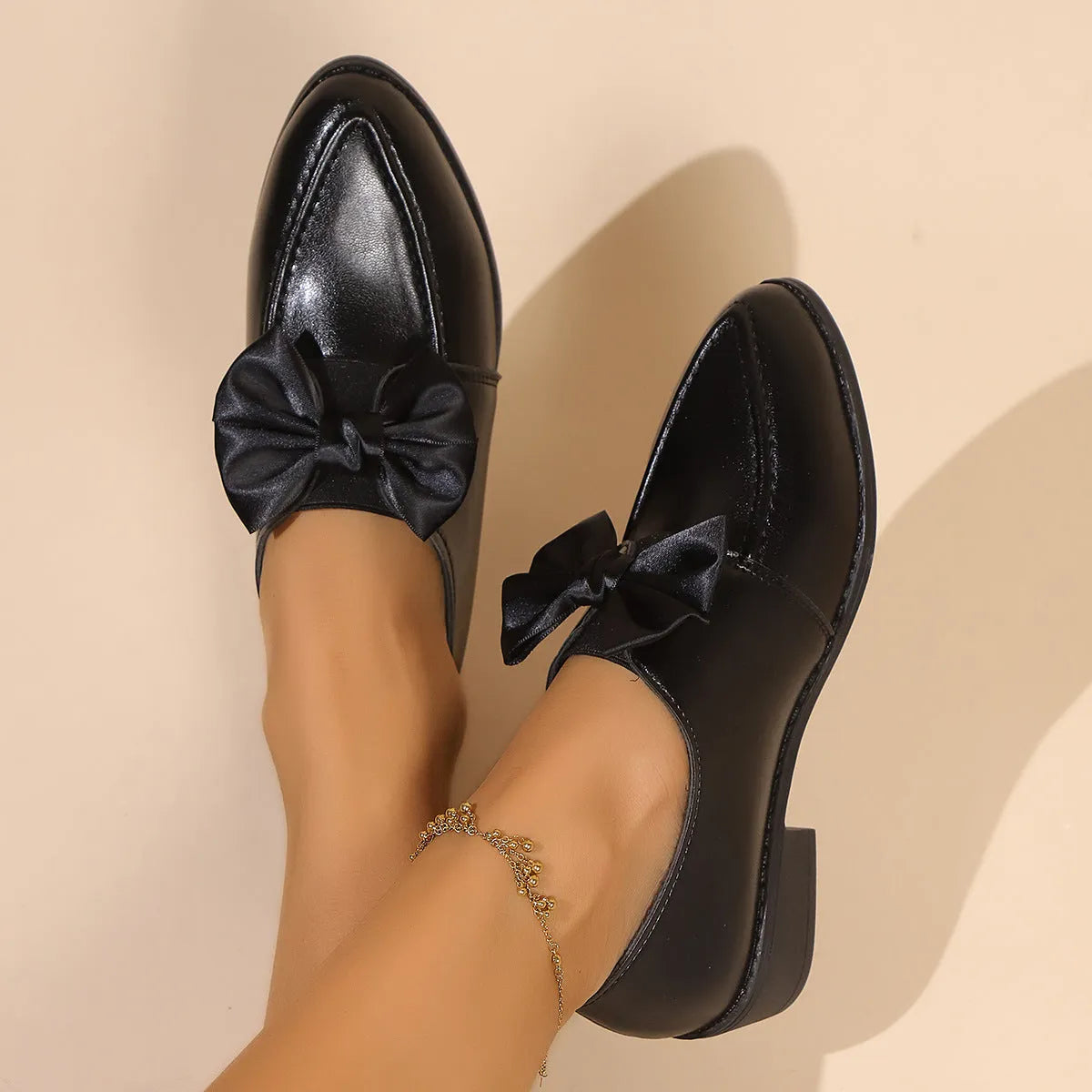 Women's slip-on shoe with a decorative bow on a pointed toe, available in buckle big bow or small bowknot styles.