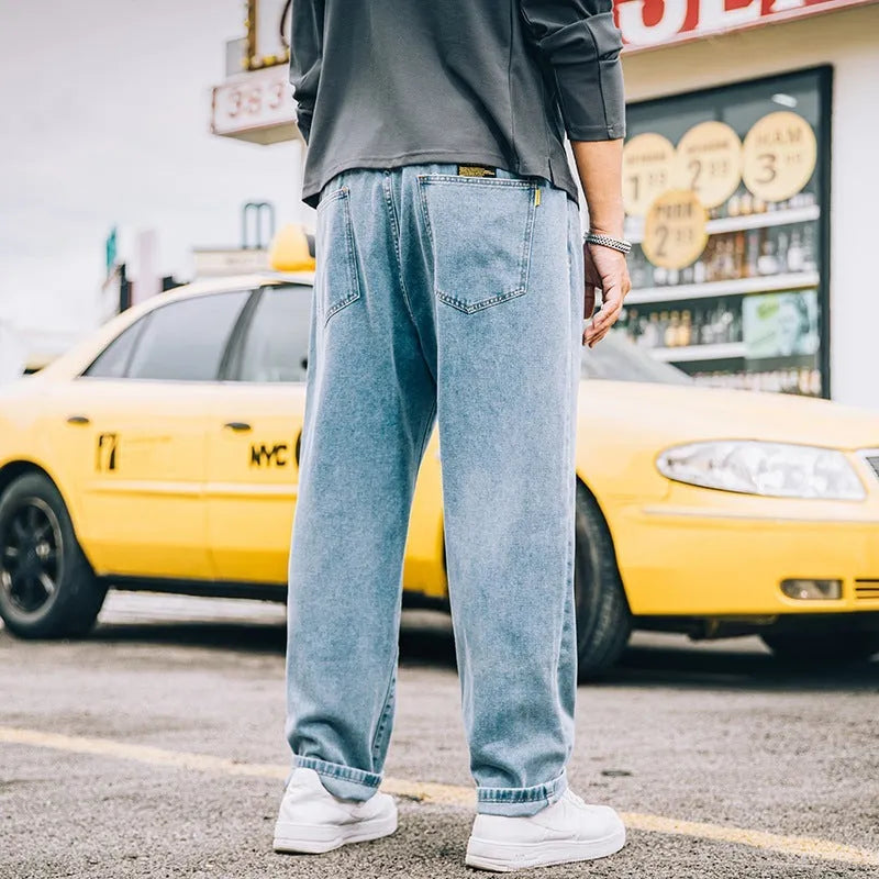 Men's loose straight leg casual jeans in cotton, shown in dark blue, light blue, and grey colours.