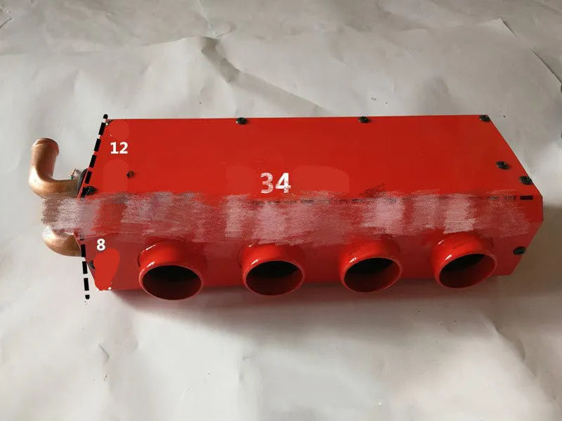 Long small metal car heater with four-hole copper pipe connections for 12V 24V systems.