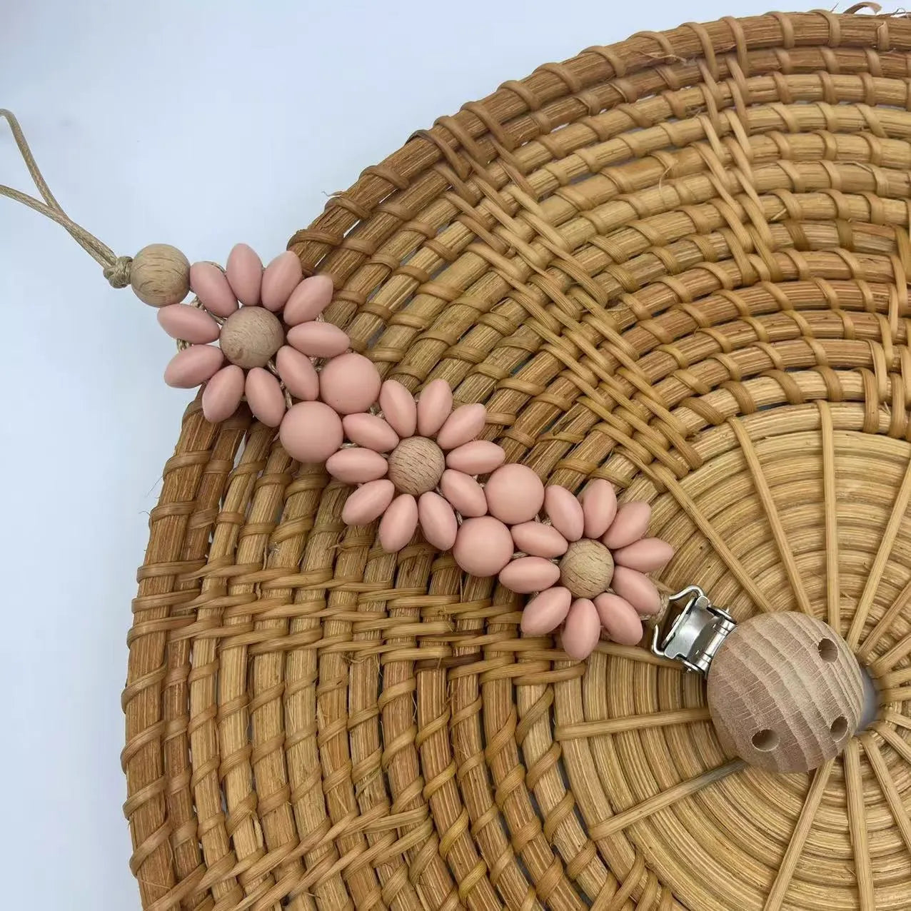Baby flower silicone pacifier clip in pink on white background with custom name option
