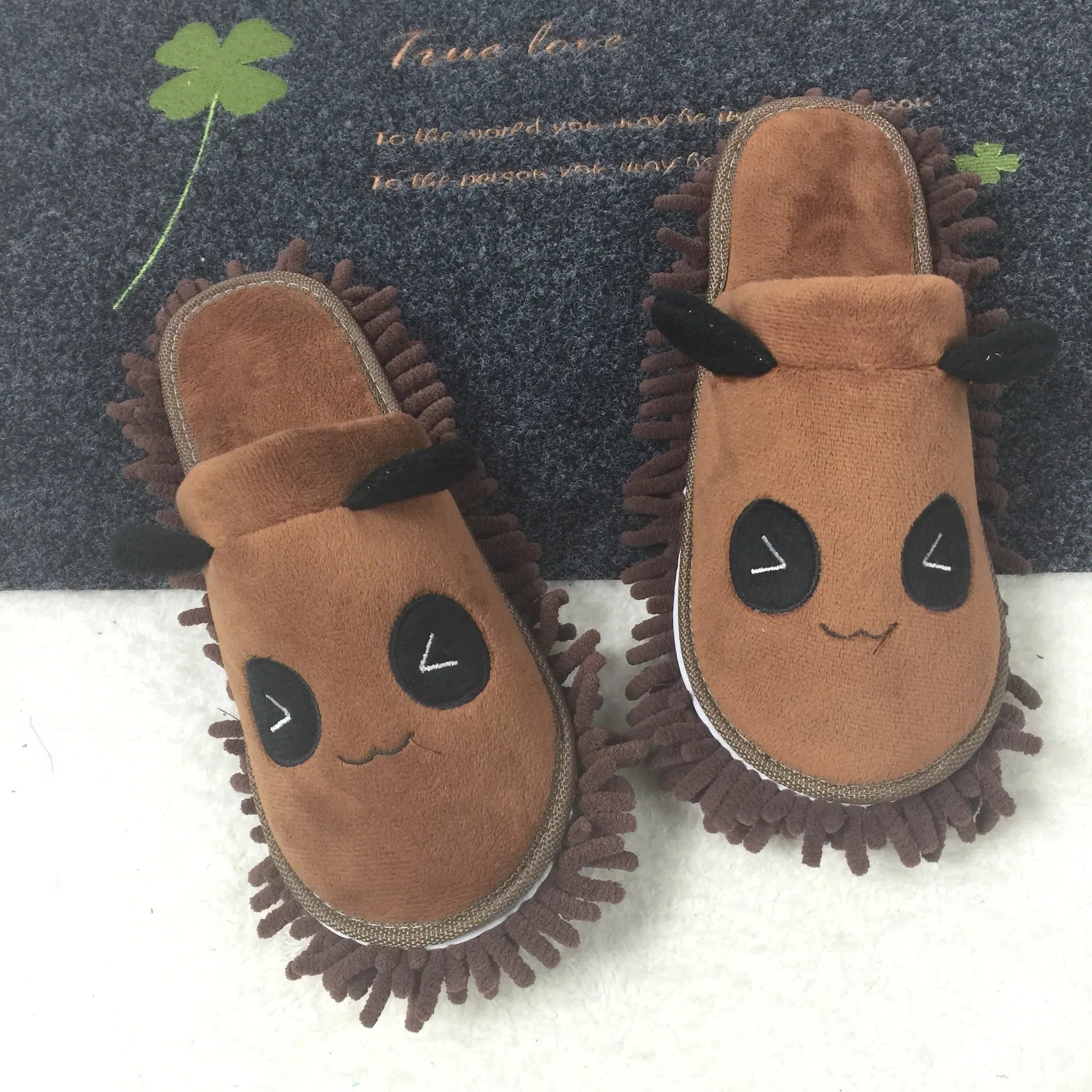 Brown animal print slippers with a removable panda face design on a coral fleece upper.