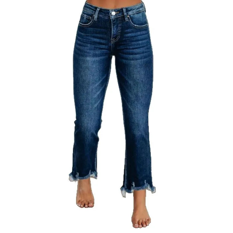 Women's solid colour denim jeans with hand-worn distressing in dark blue, laid flat.
