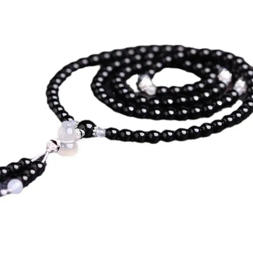 Black and red agate stone bracelet with 108 geometric beads on a wrist