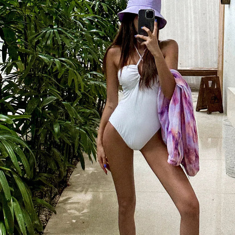 White one-piece swimsuit with hollow-out and backless design, nylon and polyester lining, sizes M L XL