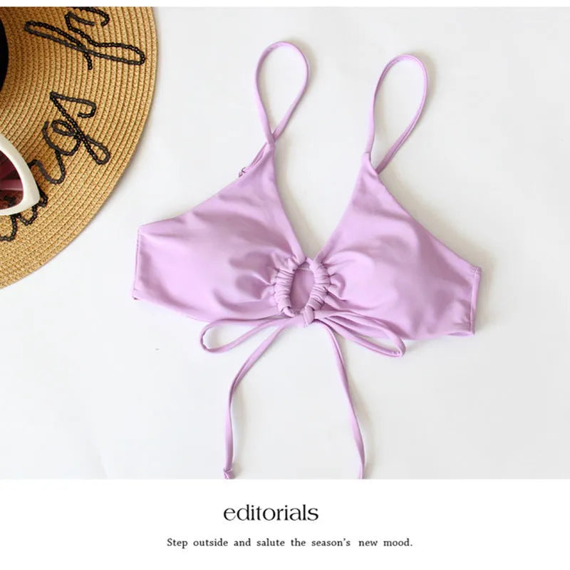 Women's solid colour bikini with a tied bow detail on the split front, shown in multiple colour options.