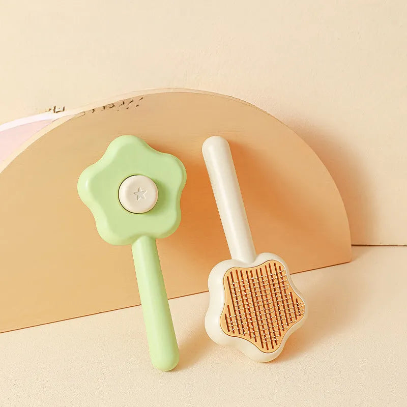 Green self-cleaning stainless steel cat comb for pet grooming on a white background