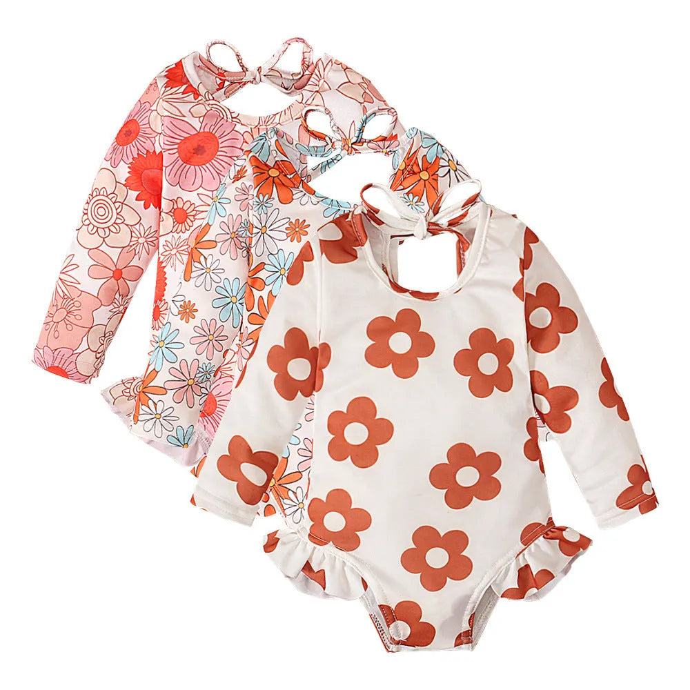 Girl's floral print open back swimsuit in orange, showing crew neck and briefs style.