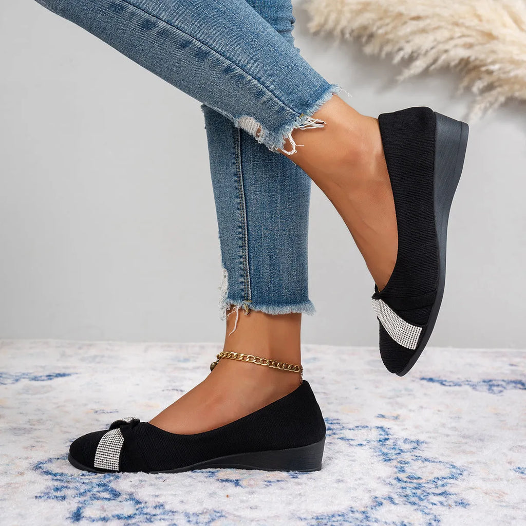 Women's black slip-on casual shoes with rhinestone decoration and a chunky heel.