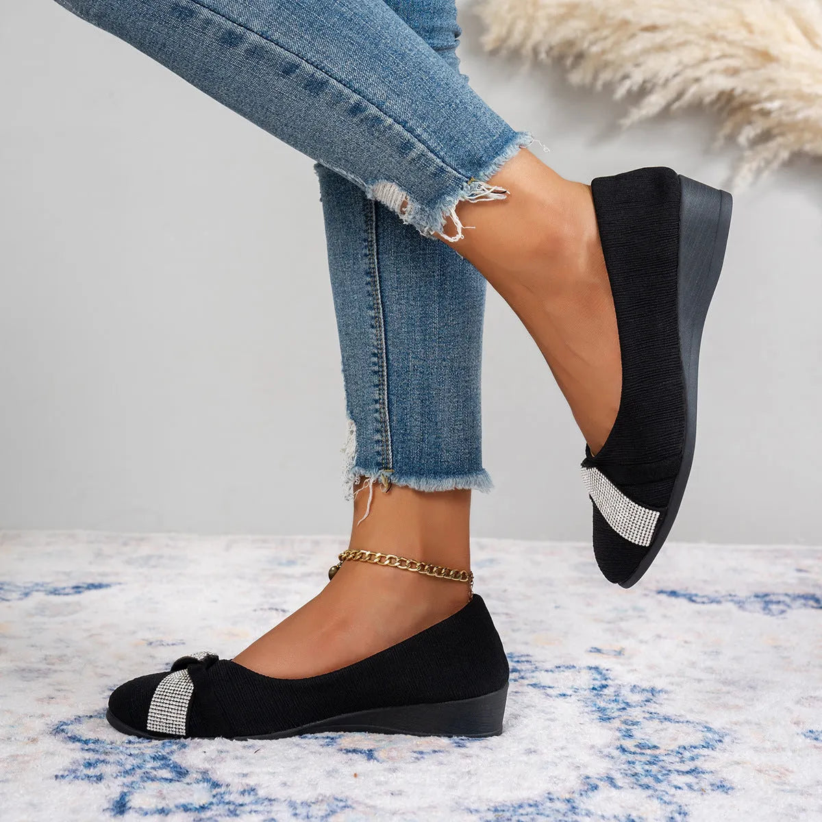 Women's black slip-on casual shoes with rhinestone decoration and a chunky heel.