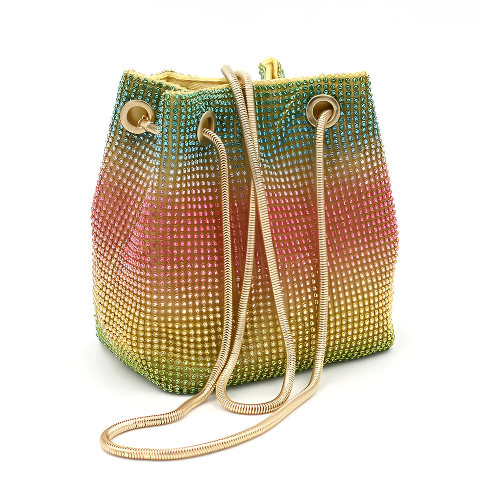 Soft rainbow rhinestone bucket handbag with adjustable strap on a white background.