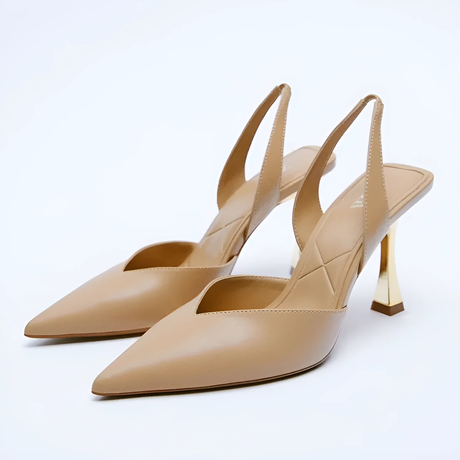 Women's patent leather pointed high heels in apricot colour showing shallow mouth toe design.