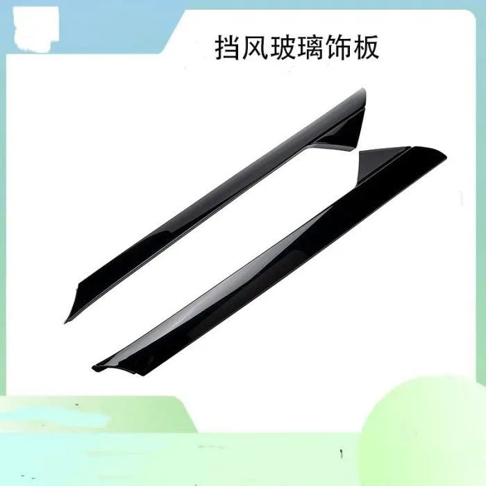 Black front windshield decorative trim panel for Ford vehicles, side view.