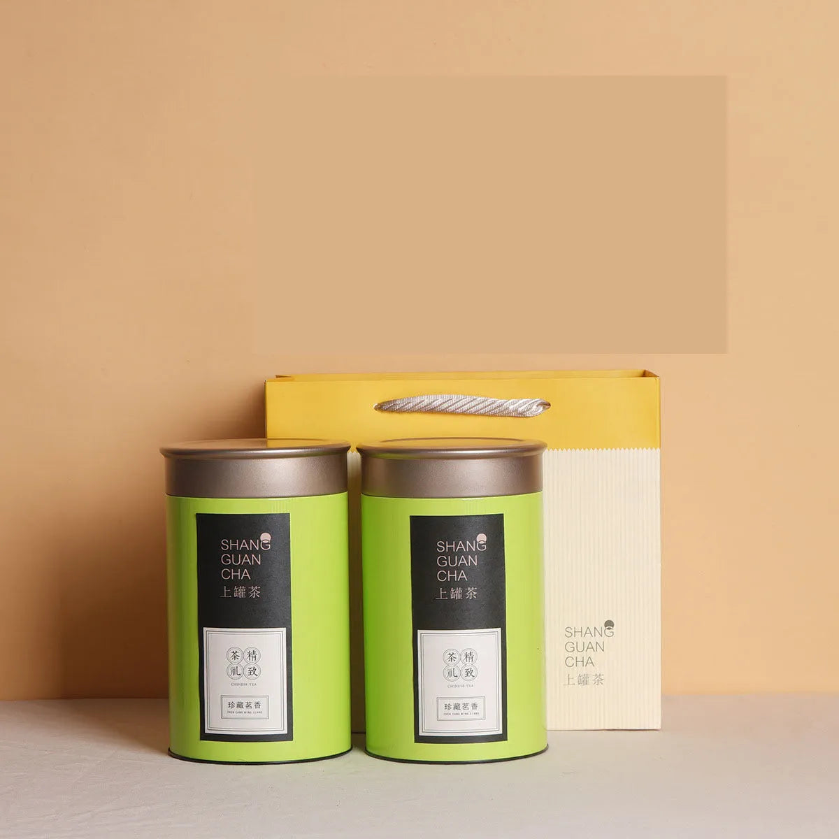 Green airtight tinplate tea storage can with sealed lid, 155mm tall.