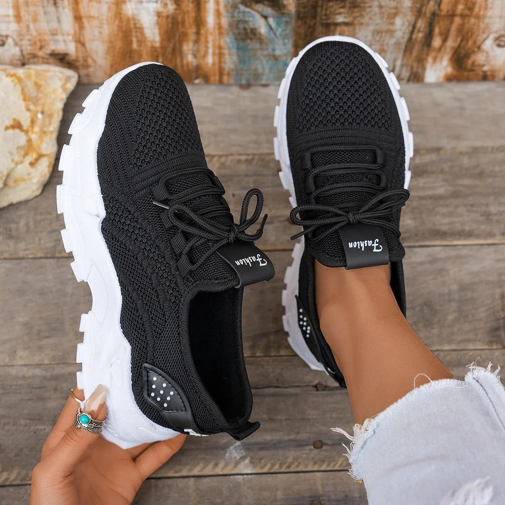Women's Flyknit mesh casual trainer in multiple colours on a white background, showing lace-up front and round toe design