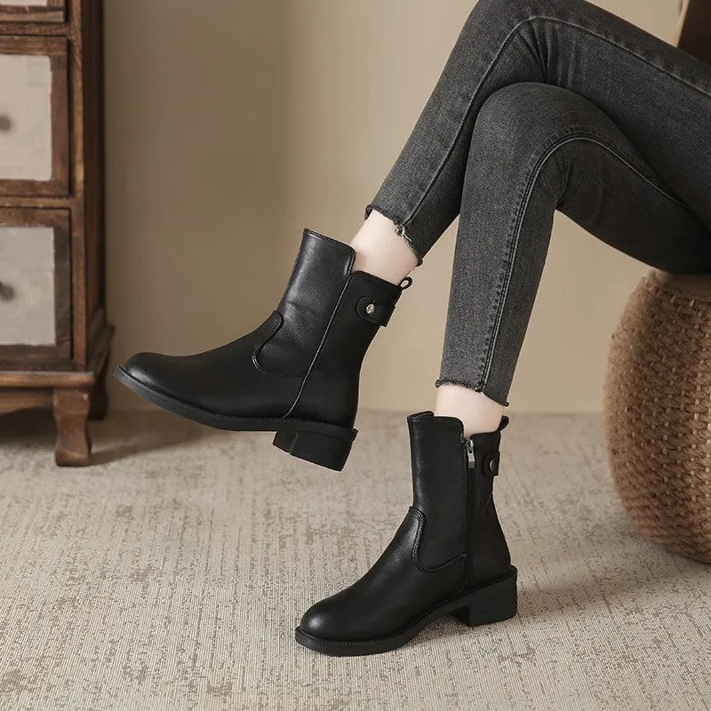 Black women's low heel ankle boots with side zip closure and round toe on a rubber sole.