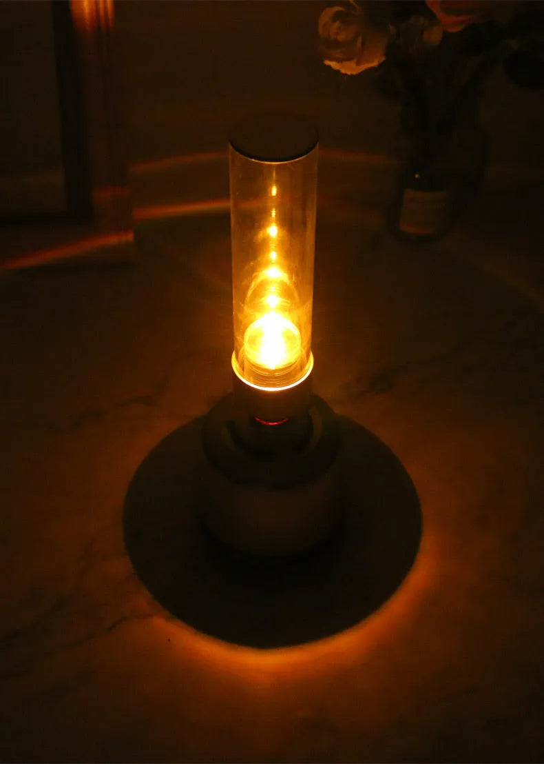 White silver cylindrical Bluetooth speaker with candlelight glow, showing push buttons, dimensions 90mm by 277mm.