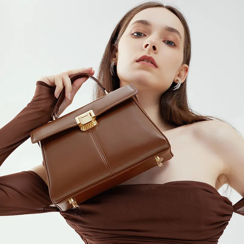 Black genuine leather women's shoulder bag with a front clasp, shown with a detailed view of the internal zip pocket.