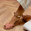 Knee-high peep toe sandals with a buckle fastenings in black, green, pink, and purple colours