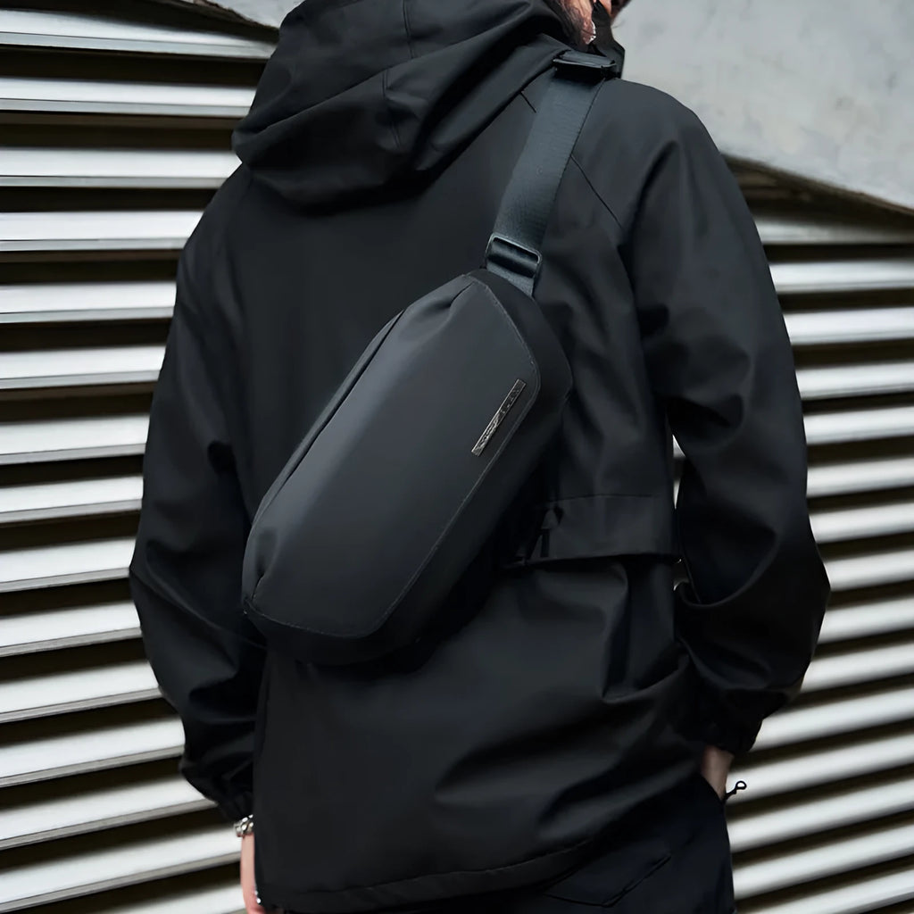 Black oxford cloth men's messenger bag with one-shoulder riding strap and decorative sewing thread.