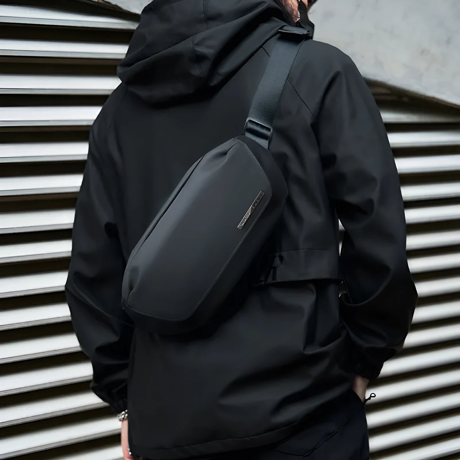Black oxford cloth men's messenger bag with one-shoulder riding strap and decorative sewing thread.