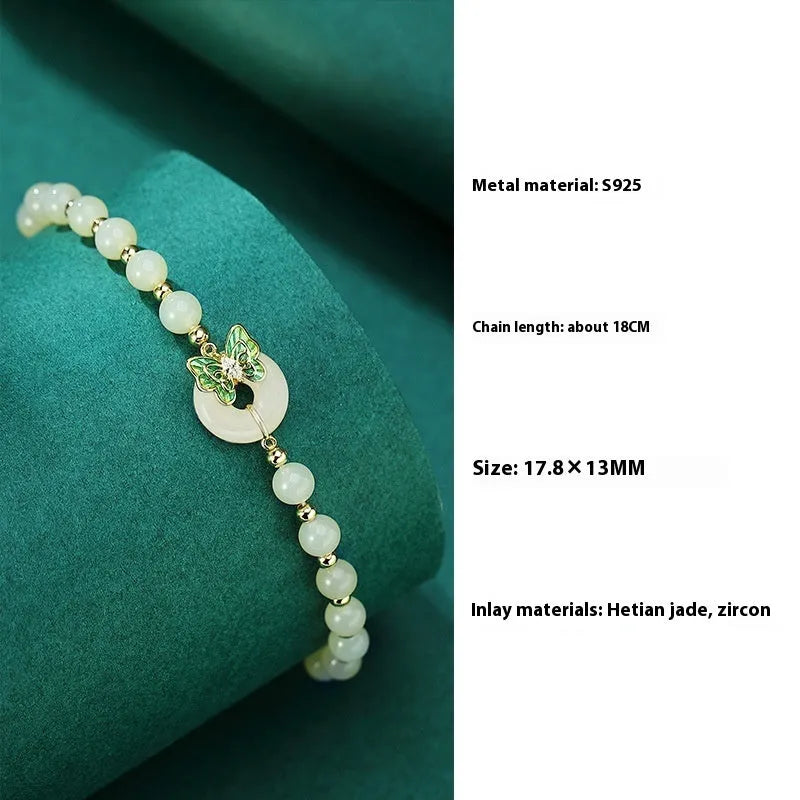 Cyan Hetian Jade bracelet with butterfly design and sterling silver accents, 6mm bead size