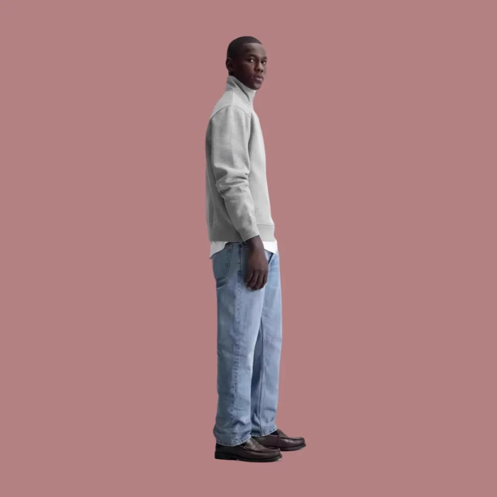 A grey half-zip stand collar cotton sweater laid flat, showing the front zip and long sleeves.