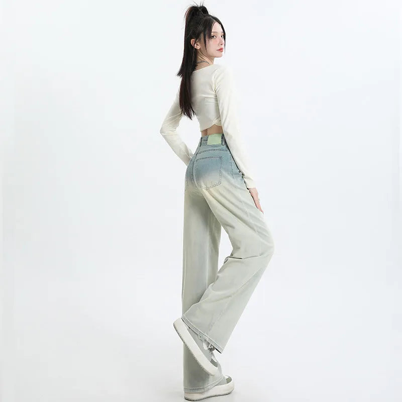 Women's gradient blue straight-leg denim trousers on a hanger.