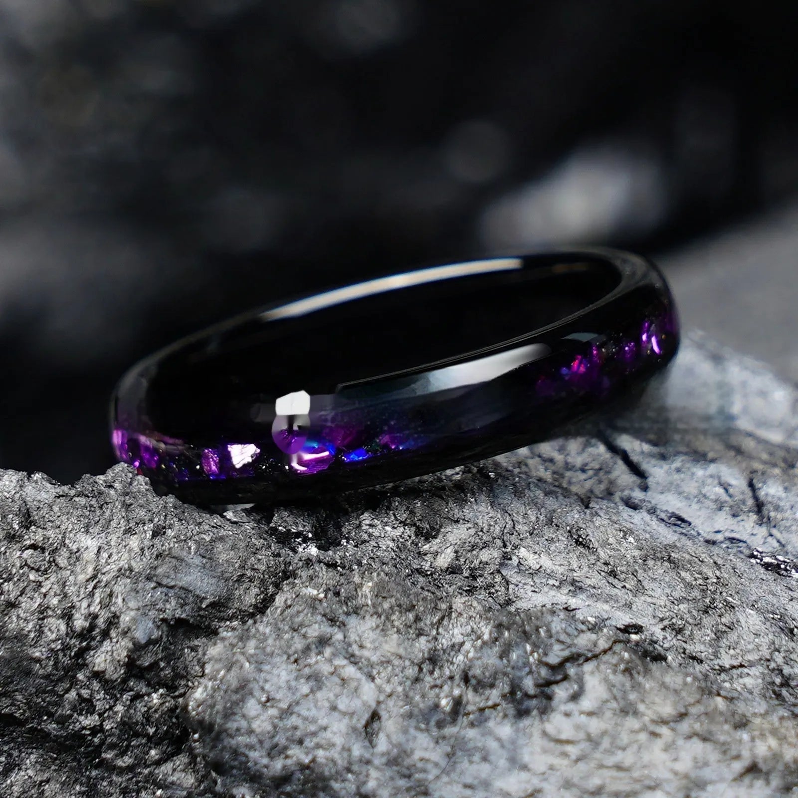 Galaxy tungsten ring with electroplated black finish and coloured inlay on a plain background