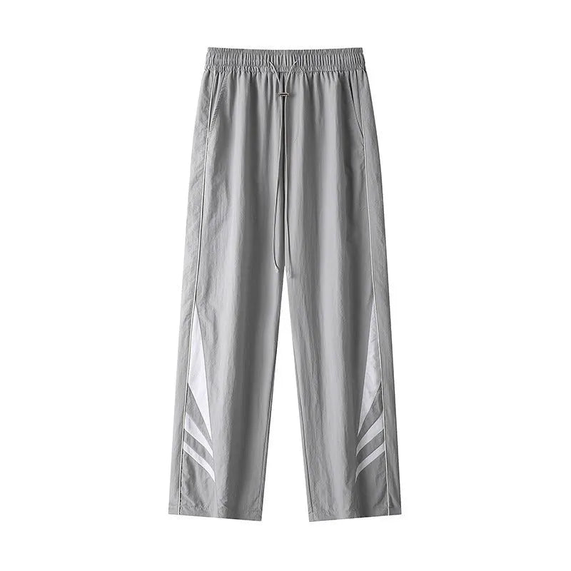 Men's straight-leg casual trousers in black, showing loose fit and button fly detail.