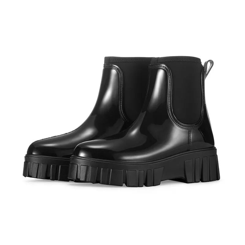 Creamy-white low tube PVC rain boots with a flat heel and non-slip sole on a plain background.