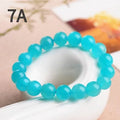 Polished natural Amazonite scattered beads in blue-green tones, shown loose and on a bracelet cord.
