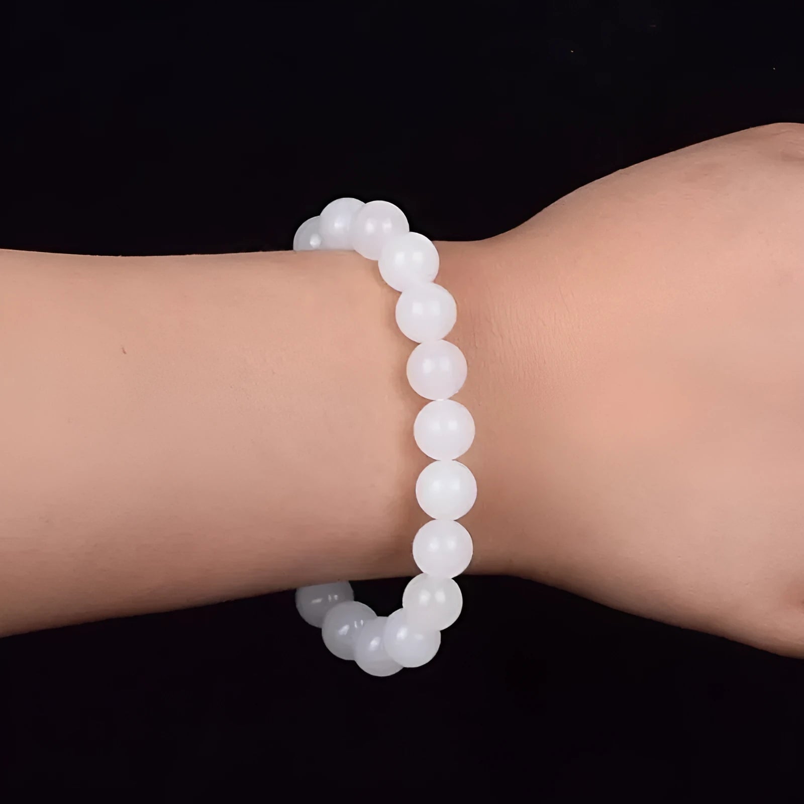 Hotan white jade goat fat round bead bracelet with 10mm Hetian jade beads on a neutral background