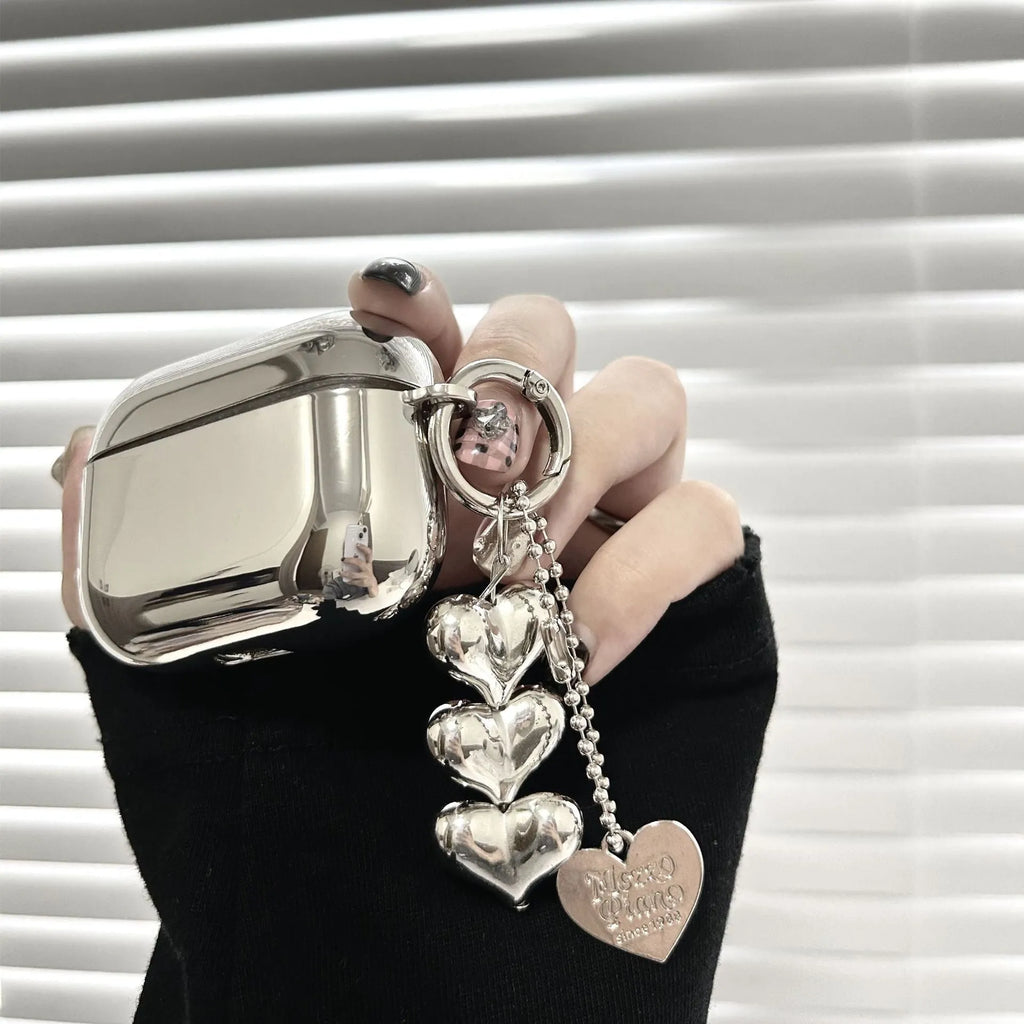 Electroplated solid colour TPU headphone case with heart pendant charms and chain for Apple earbuds.