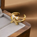 Gold geometric open band adjustable ring on a hand, showing its copper construction and modern design.