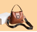 PU leather crossbody handbag with sewing line detail in brown, showing outer sandwich pocket and adjustable strap against neutral background