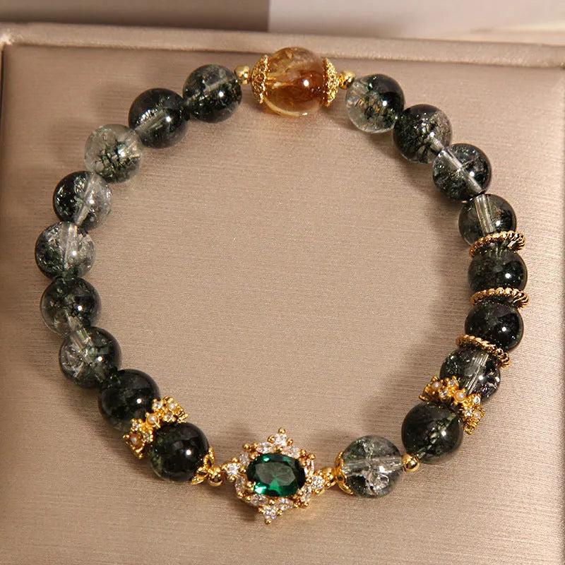 Gold rutilated quartz crystal bracelet with green phantom quartz and visible rutile inclusions