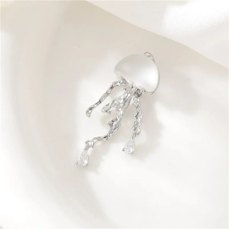 18K gold titanium steel openwork jellyfish pendant on silver O-ring chain against white background