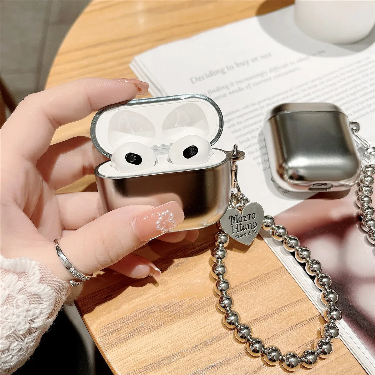Matte plating TPU protective case for AirPods with an attached bracelet strap.
