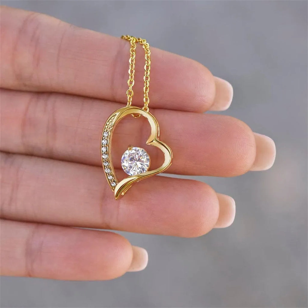 Hollow heart-shaped pendant necklace in silver or gold finish with gift box and card.