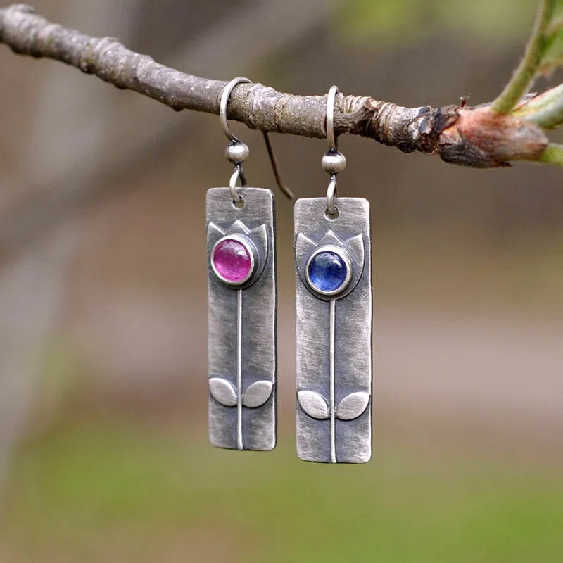 Antique finish geometric earrings with oval ellipse design and red sapphire accents