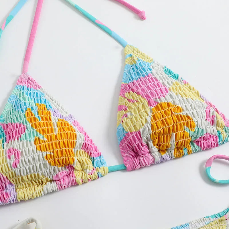 Women's triangle bag bikini swimsuit with printed floral gradient pattern and smocking detail
