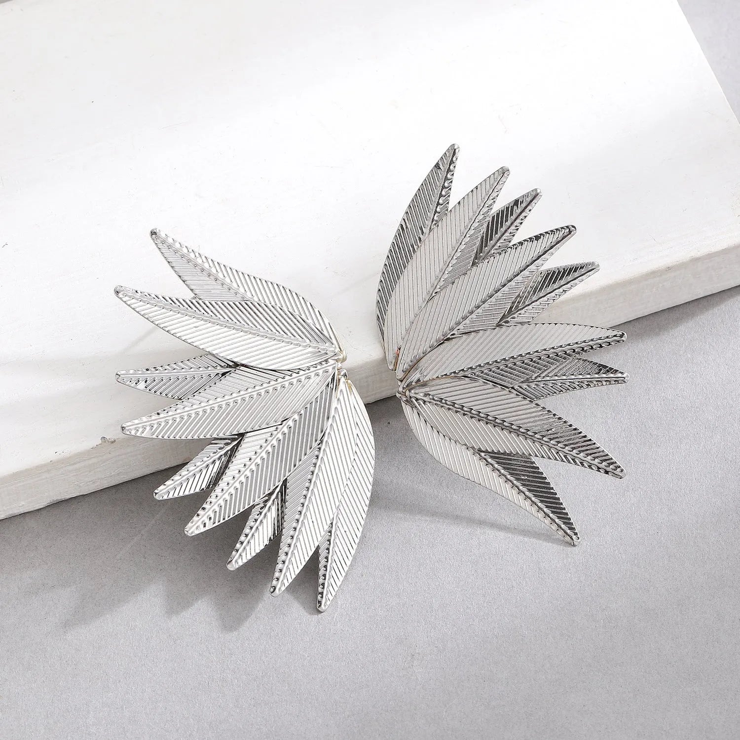 Gold and white leaves patch earrings showing detailed leaf design on alloy metal