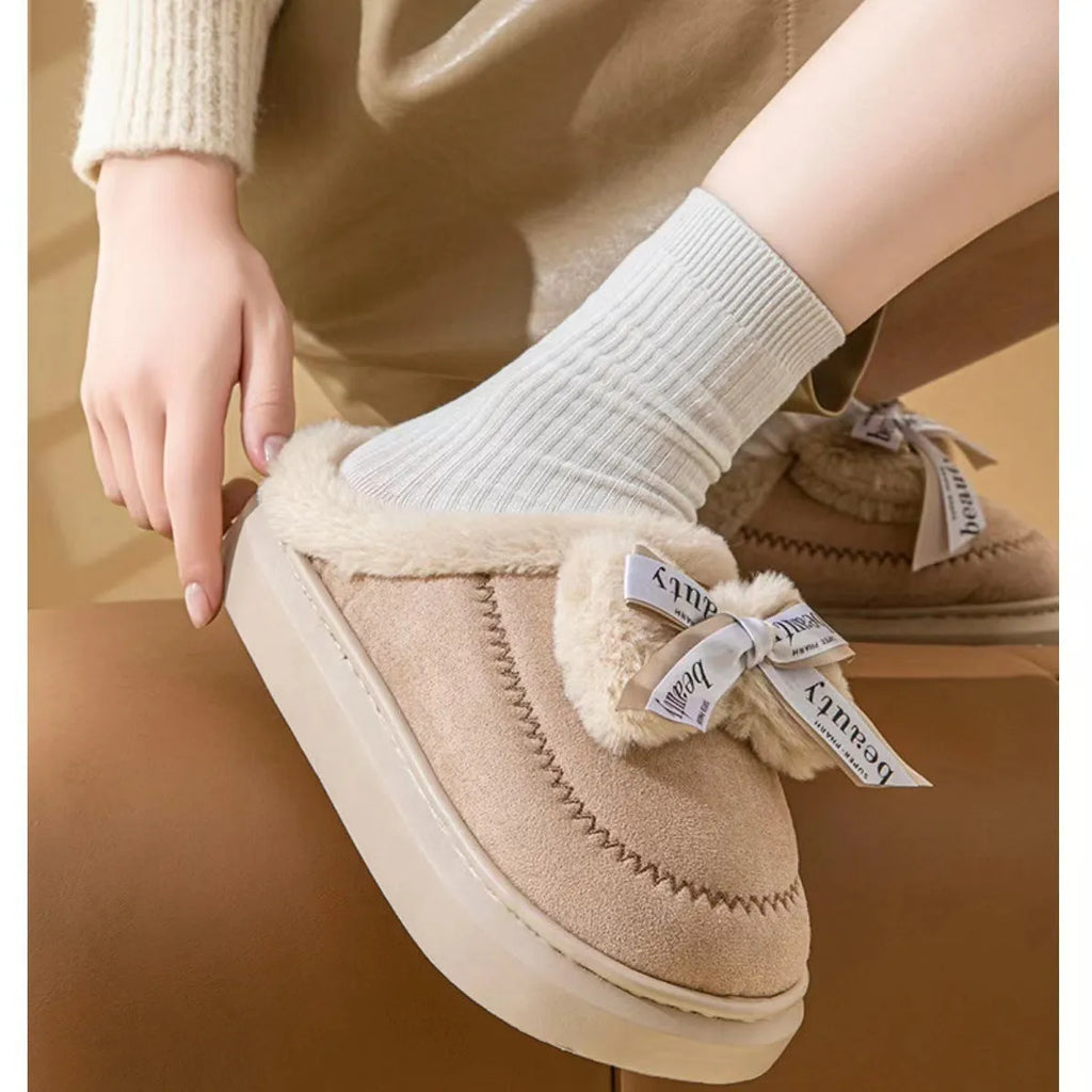 Women's beige suede half slippers with a ribbon bow and thick sole.