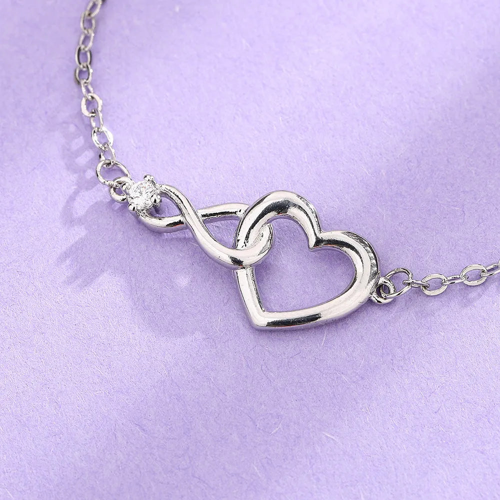 Heart-shape copper bracelet with clear 3A zirconia stone on adjustable chain in platinum finish