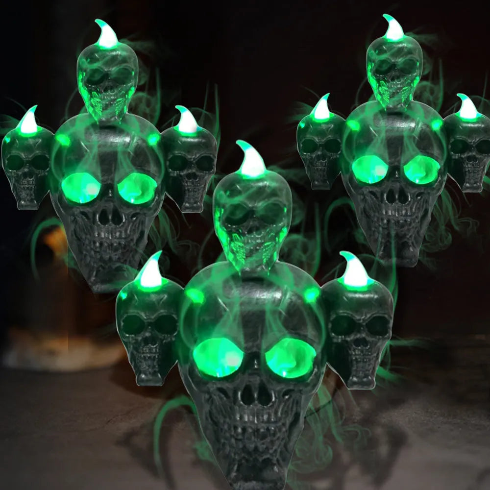 Golden skull ornament with LED light shaped like a skeleton hand holding a candle