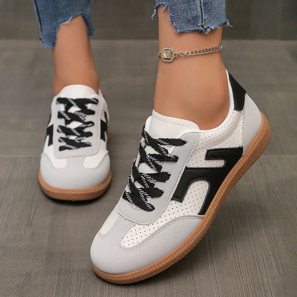 Women's low top casual sneaker in retro style with round toe and lace-up front.