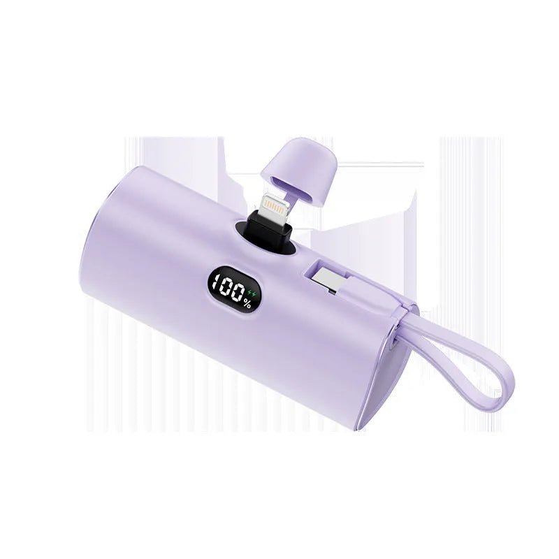 Capsule-shaped wireless power bank with digital display in blue colour showing battery percentage.